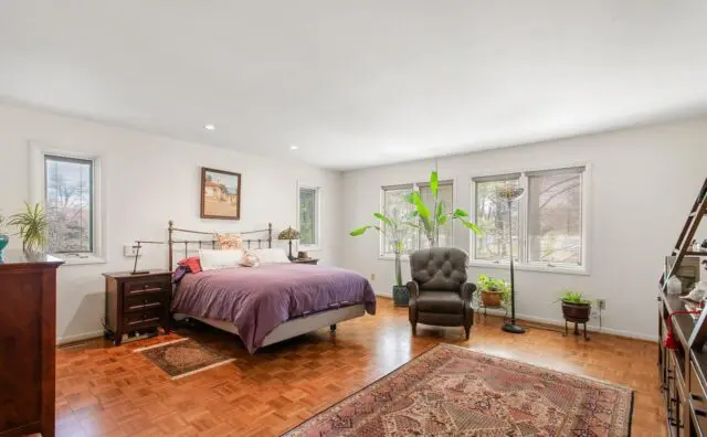 Modern Bryn Mawr bedroom with hardwood floors and stylish bed 