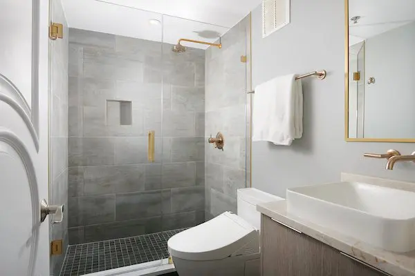Modern bathroom with shower, toilet, sink (One Hundred East Huron, Chicago) 