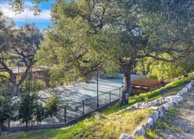 Inside the Upscale-Rustic Ranch of Movie Mogul Robert Daly, Co-Chairman of Warner Bros. 19 Onsite tennis courts surrounded by ranch greenery