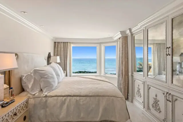 Inside the San Diego Mansion of Billionaire Entrepreneur Darwin Deason 13 Stylish guest suite with plush bedding and elegant décor