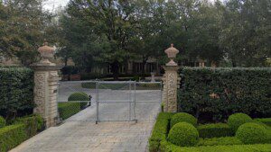 Exterior view of John Calvert's gated Dallas mansion