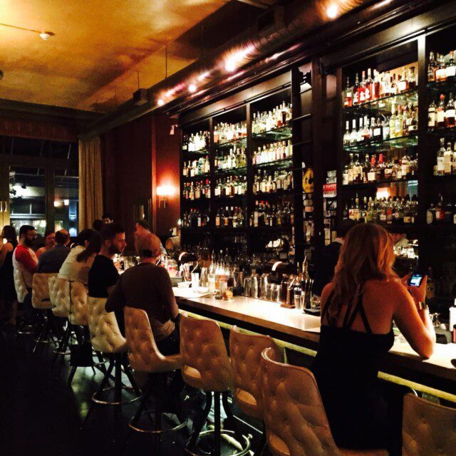 Inside Tender Bar & Kitchen in Pittsburgh, with original marble features & a visible vintage bank vault 
