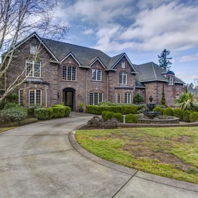 Entryway of the Kupp house in Oregon, featuring a walkway encircling a decorative fountain.