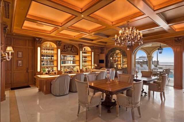 Home bar featuring elegant wood finishes and luxury seating