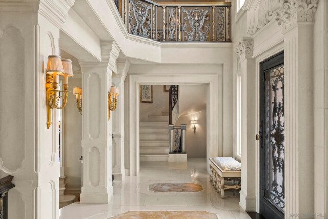 Marble-floored foyer featuring opulent metal and glass detailing