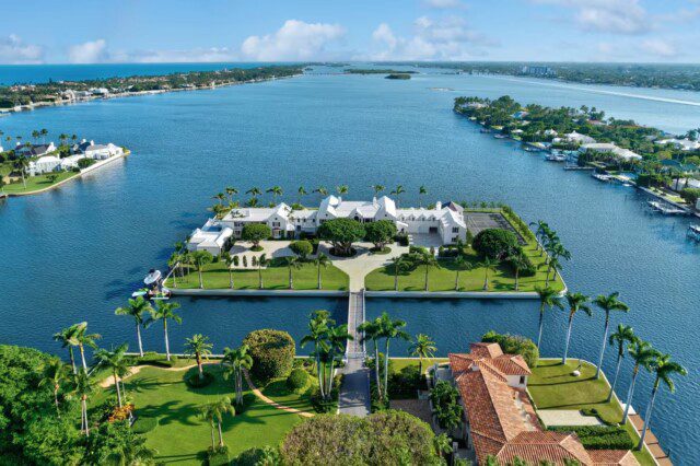 Front view of Florida waterfront of Michael Dorrell house with shaded privacy trees 