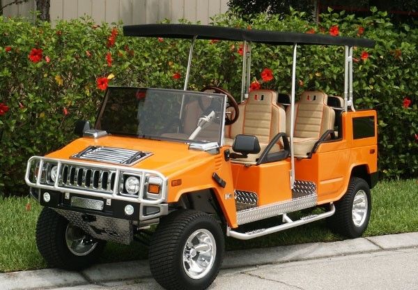 An orange Hummer golf cart with four seats