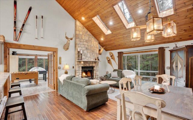 Pocono living room with fireplace, wood floors in Pennsylvania lake house