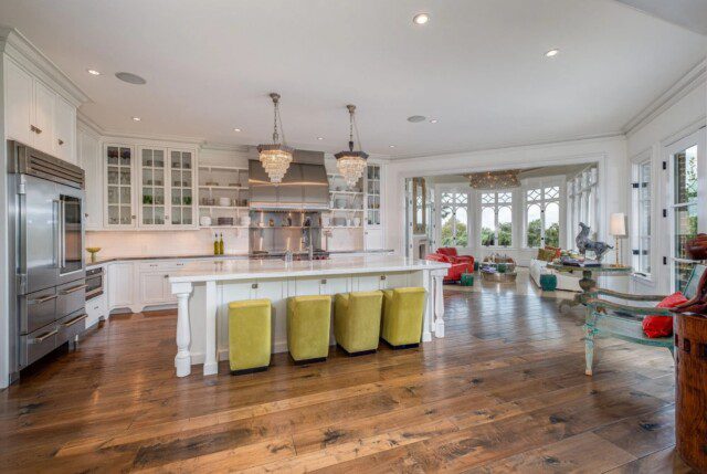 Gourmet kitchen in Dave Ramsey’s home, featuring a functional layout with access to a cozy sunroom. 