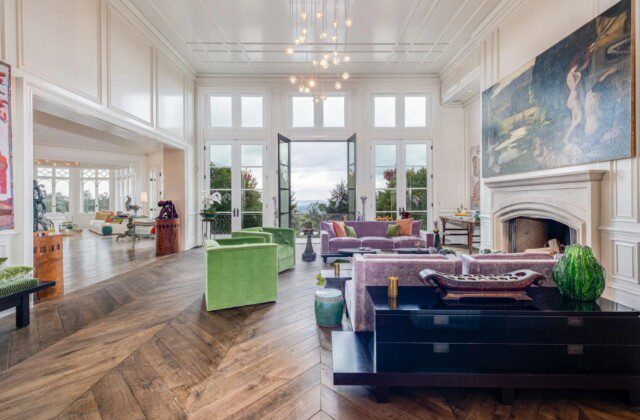 Living room in Dave Ramsey’s mansion, designed with large windows and breathtaking Tennessee mountain views. 