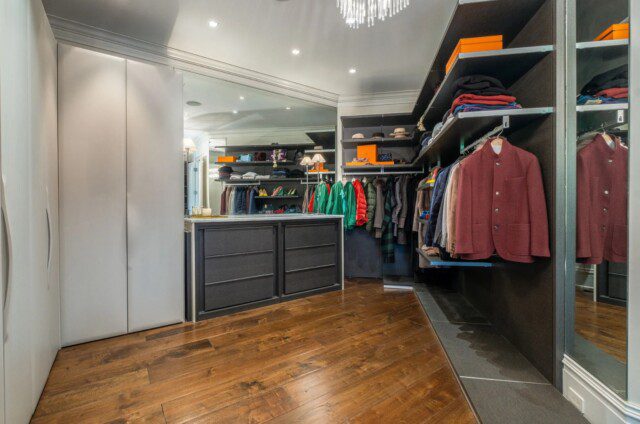 Master closet in Dave Ramsey’s home, designed for luxury and organization. 