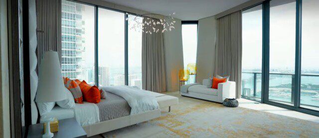 Spacious, airy bedroom with floor-to-ceiling views of Miami in Ridinger home
