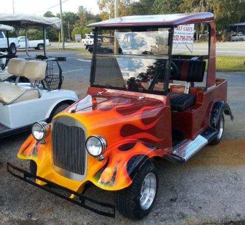 Customized Roadster golf cart with fiery flames painted on the sides