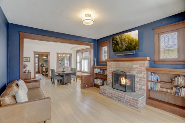 Seattle Craftsman living room - Cozy blue walls, brick fireplace 