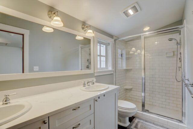 Seattle Craftsman bathroom - Luxurious white, dual sinks, sleek shower 
