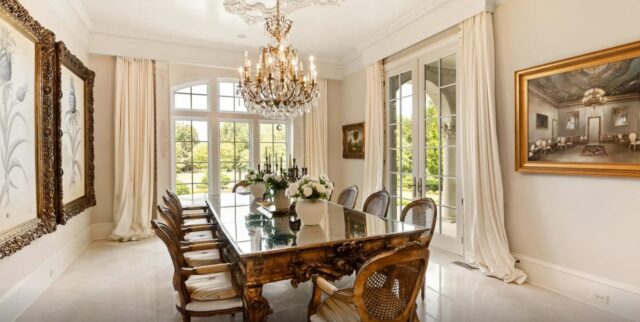 Elegant dining room with a chandelier and marble floors in a Waxhaw mansion