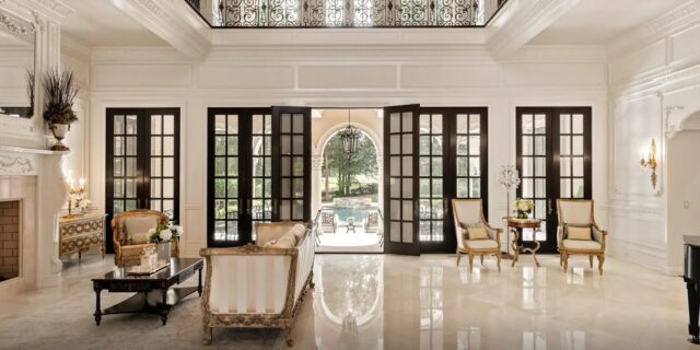 Luxurious foyer with high ceilings and marble flooring in a French-inspired estate